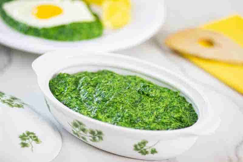 bowl with spinach on table